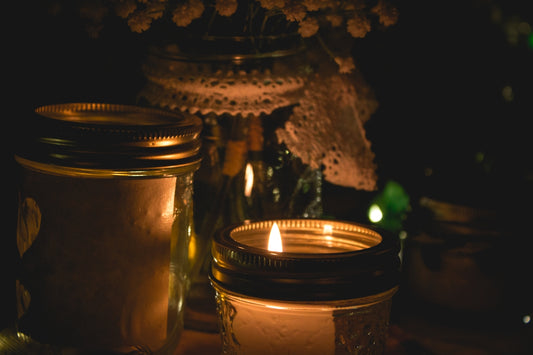 lighted candle in glass candle holder