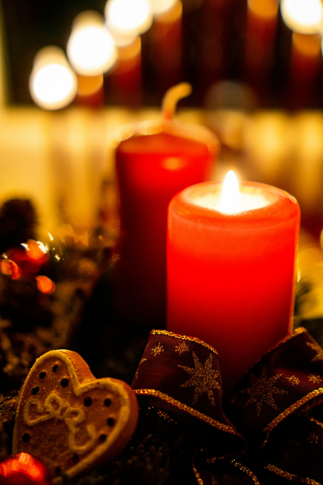 a couple of red candles sitting on top of a table