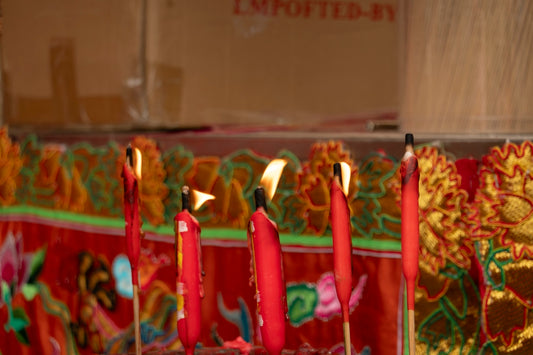 a group of red candles sitting on top of a table