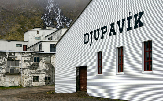 A white building with a sign on the side of it